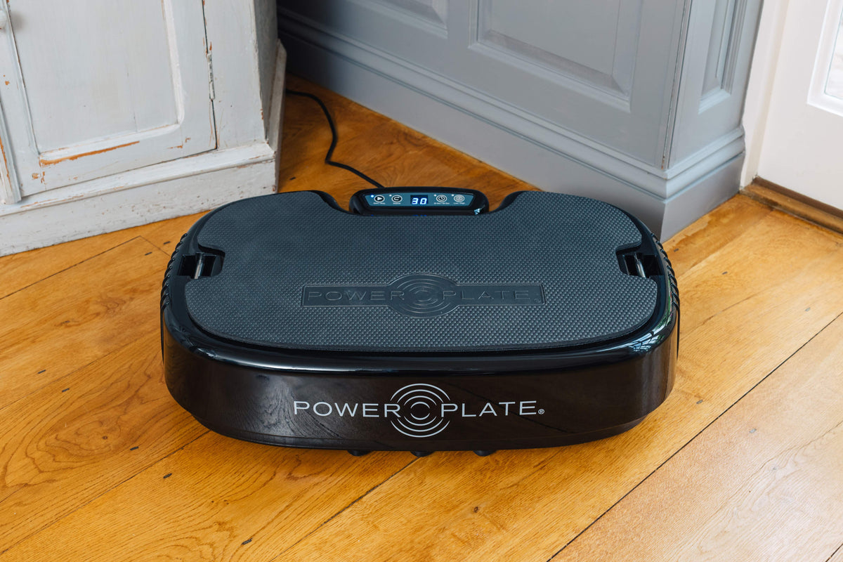 Personal Power Plate on a wooden floor at home