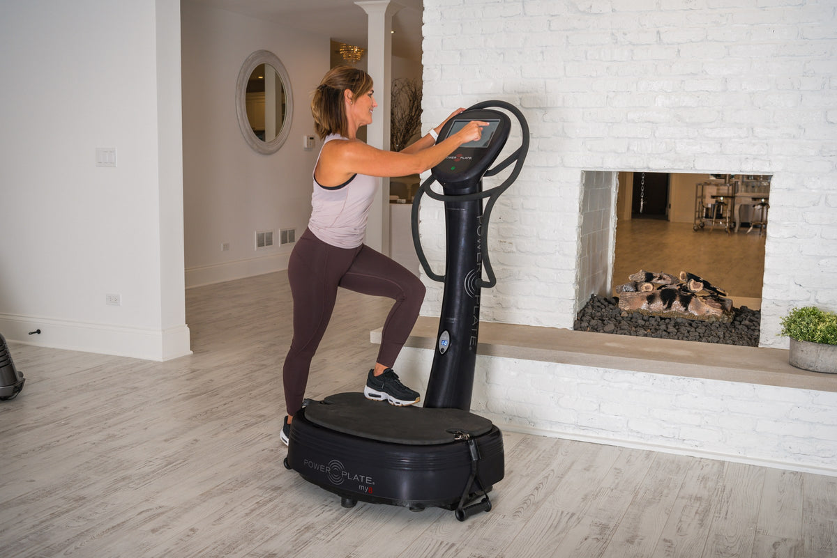 Woman exercising on the Power Plate my8 at home